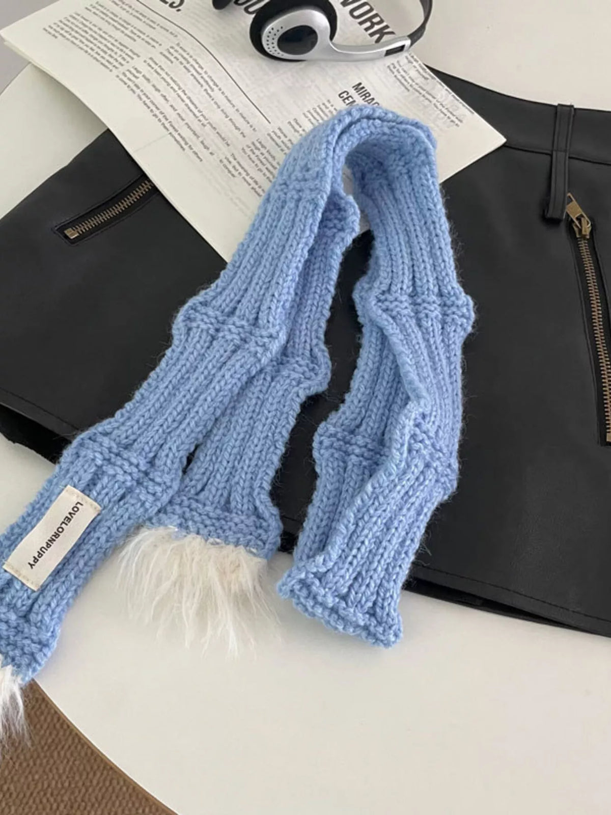 Unisex Plush-Tip Skinny Knit Scarf — blue narrow knit scarf laid with long ends visible