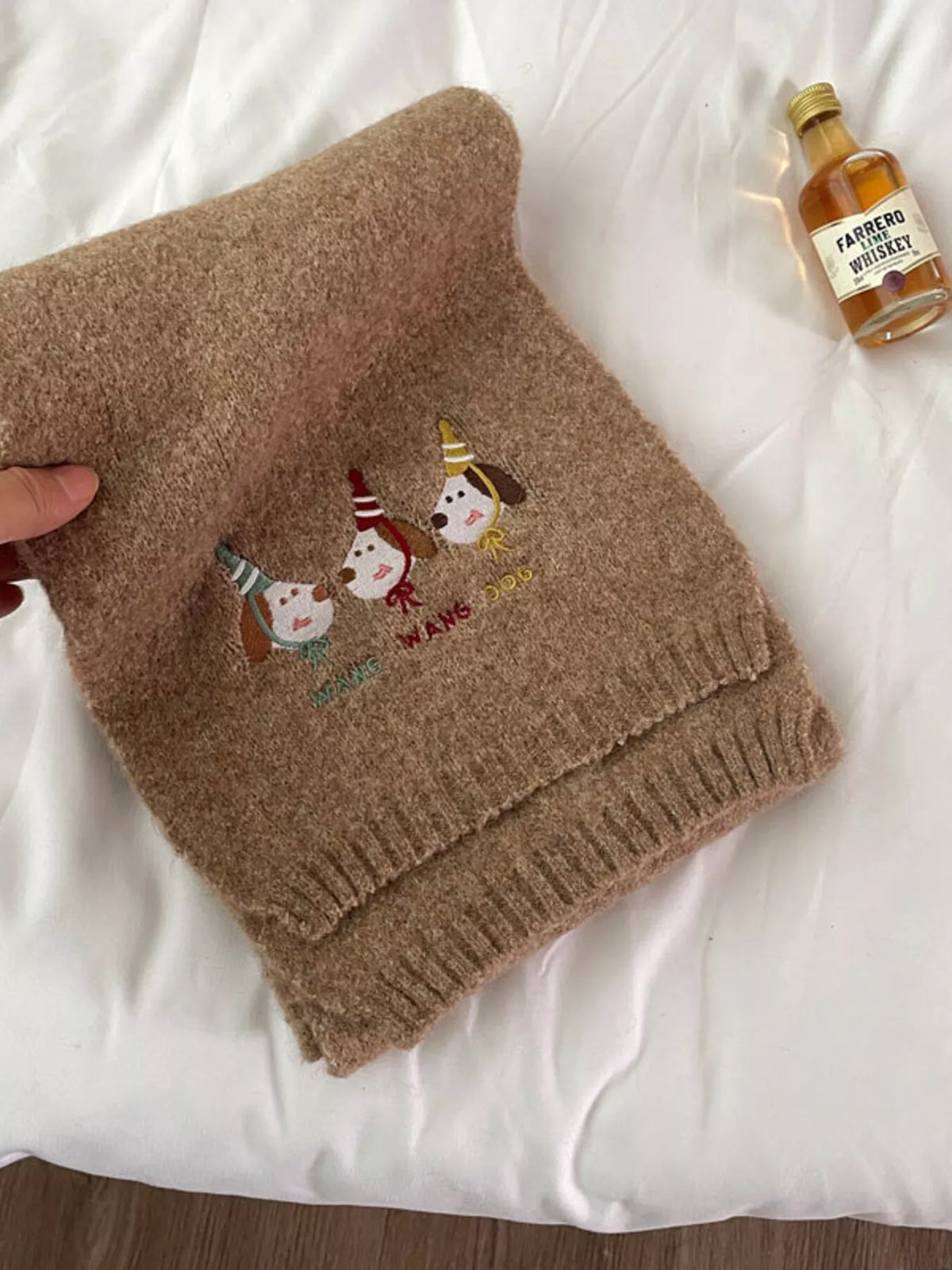 Unisex Embroidered Dog Knit Scarf — close view of embroidered dogs on the khaki scarf