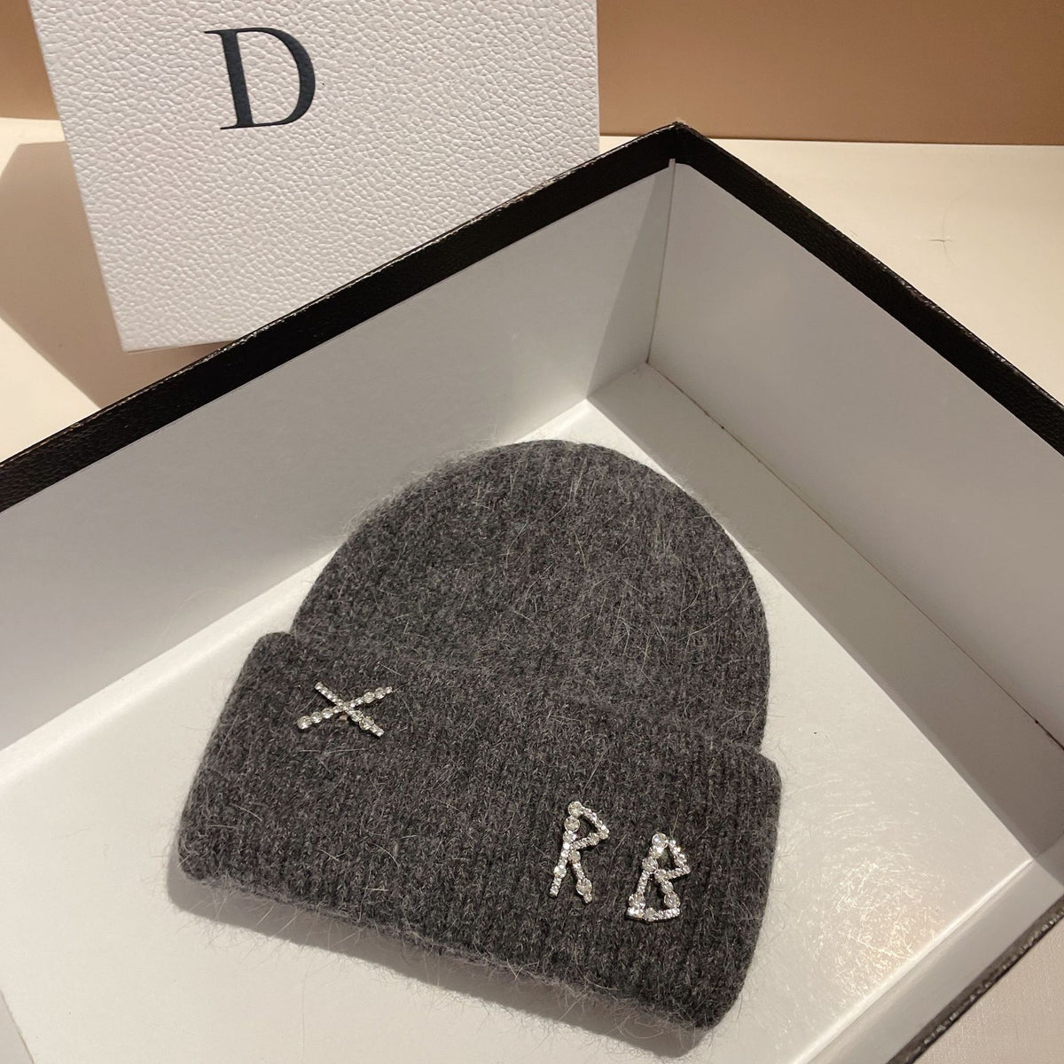 Women's Rhinestone Embellished RB Letter Knit Winter Beanie — dark gray RB letter beanie in an open box