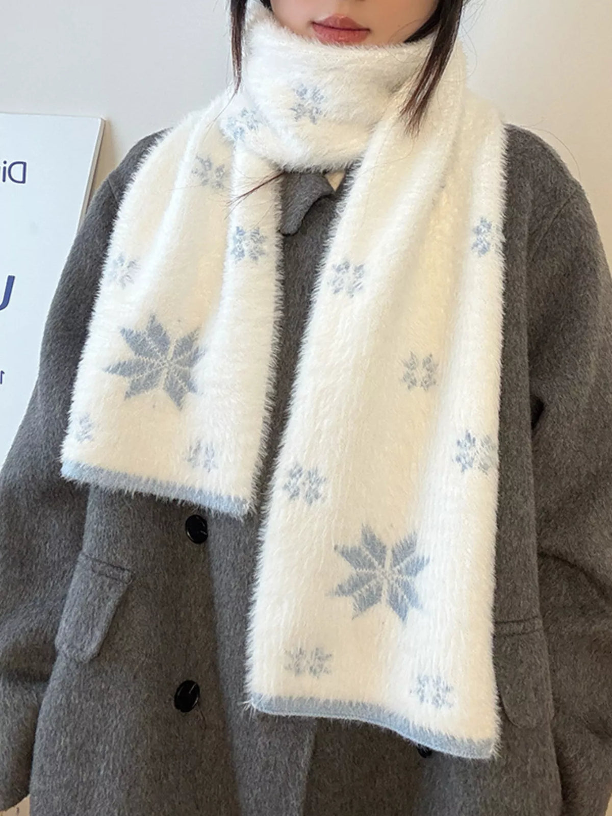Unisex Snowflake Plush Knit Scarf — blue motif scarf worn open over a dark coat