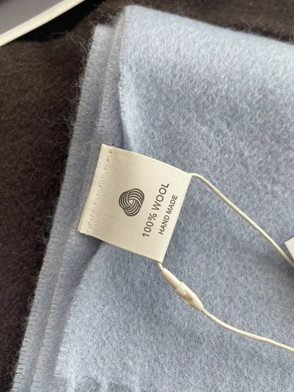 Unisex Azure Wool Fringe Scarf — close view of blue wool scarf and attached tag