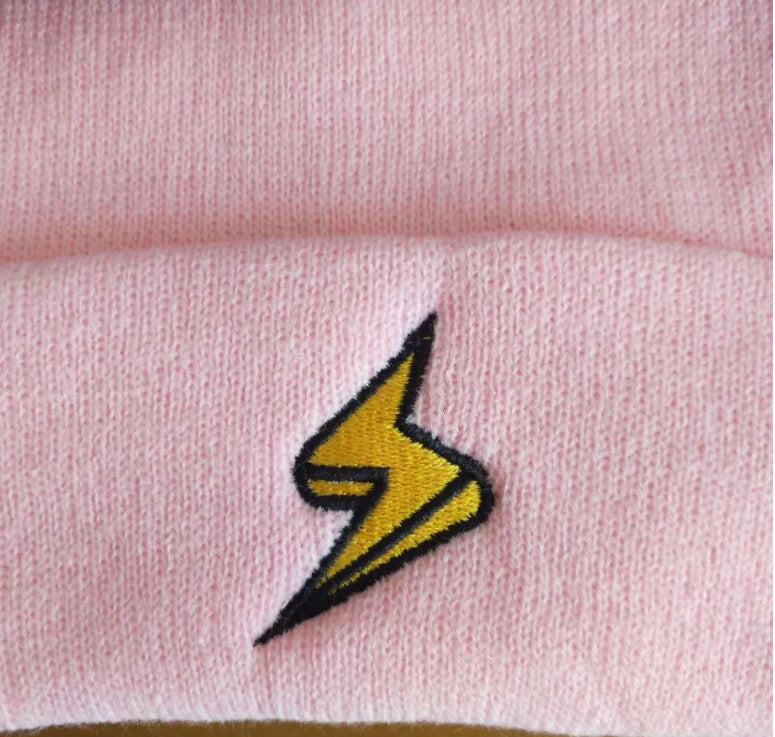 Close-up of the yellow lightning bolt on pink knit fabric