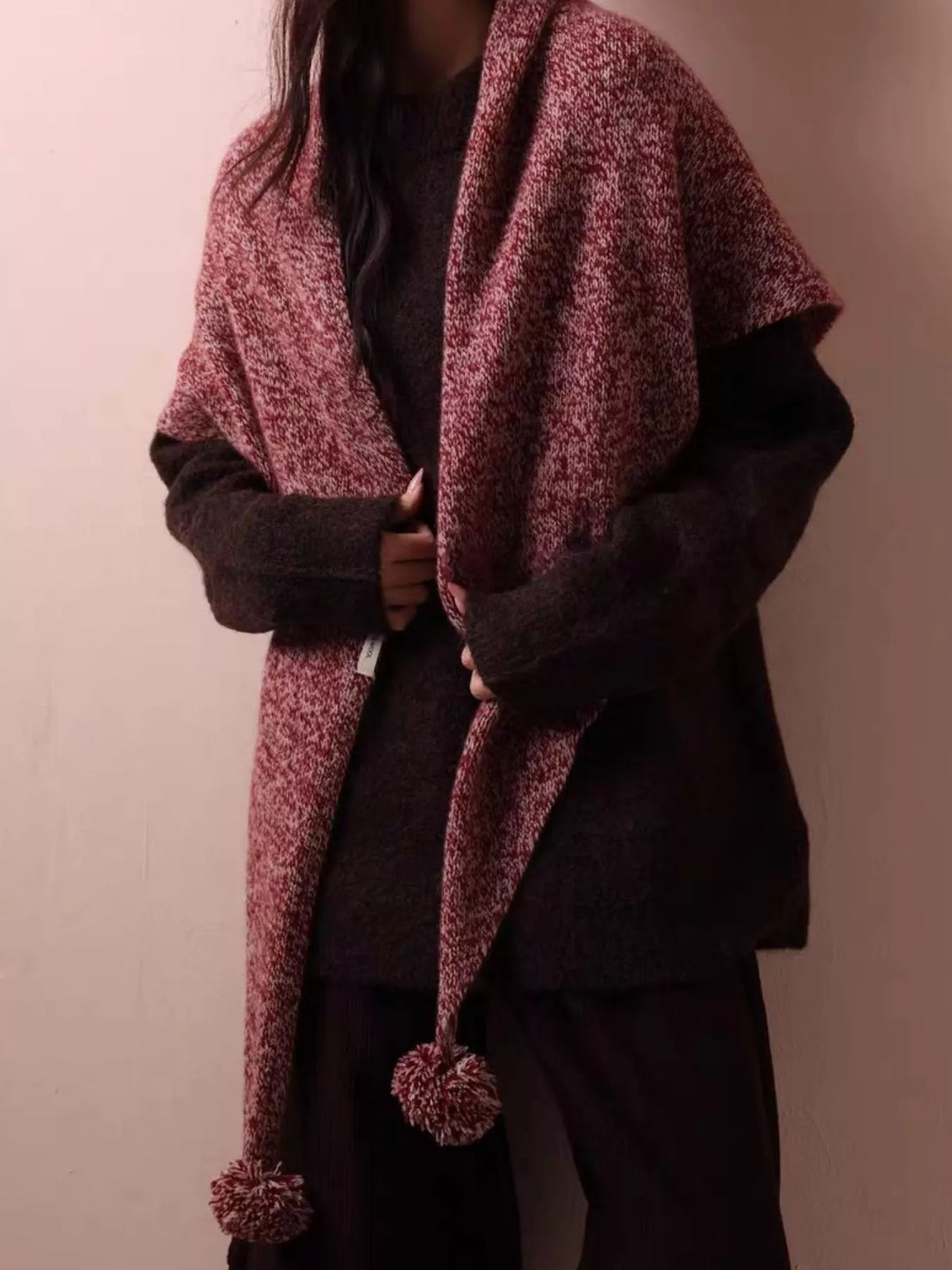 Women's Wool Pom-Pom Shawl — coral shawl worn across a dark sweater