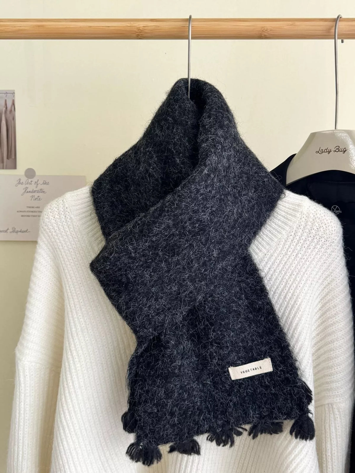 Unisex Tassel Knitted Scarf — black wool scarf crossed over a white knit top