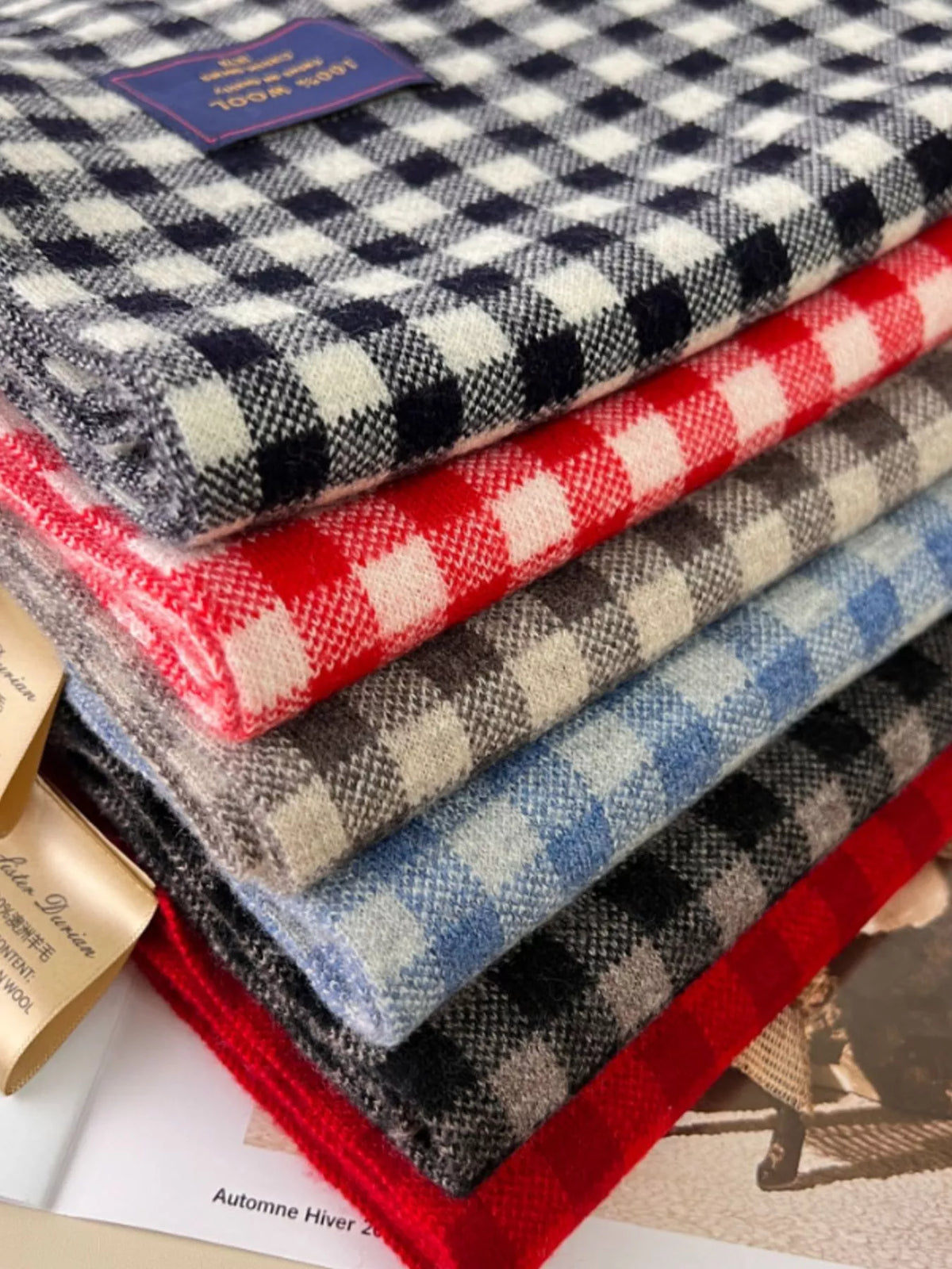 Unisex 100% Wool Plaid Scarf — stack of wool plaid scarves showing contrasting checks