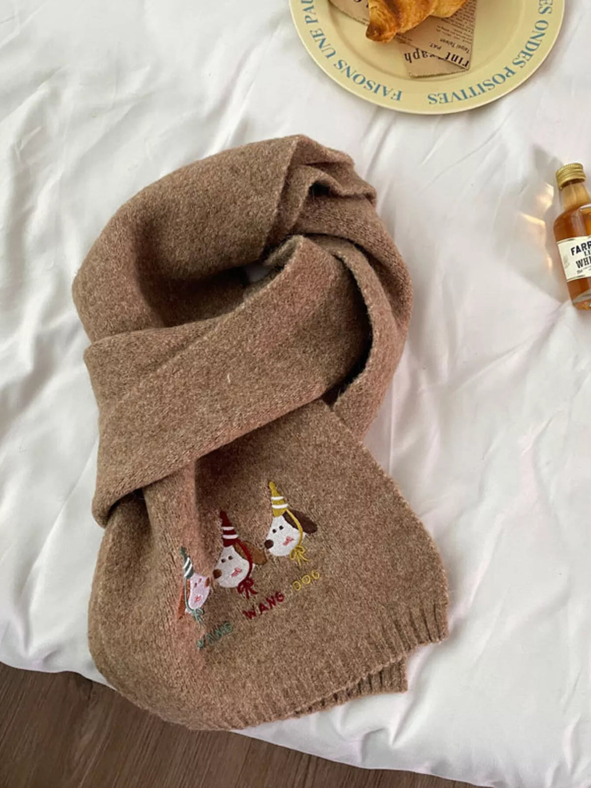Unisex Embroidered Dog Knit Scarf — khaki scarf with dog illustrations near the end