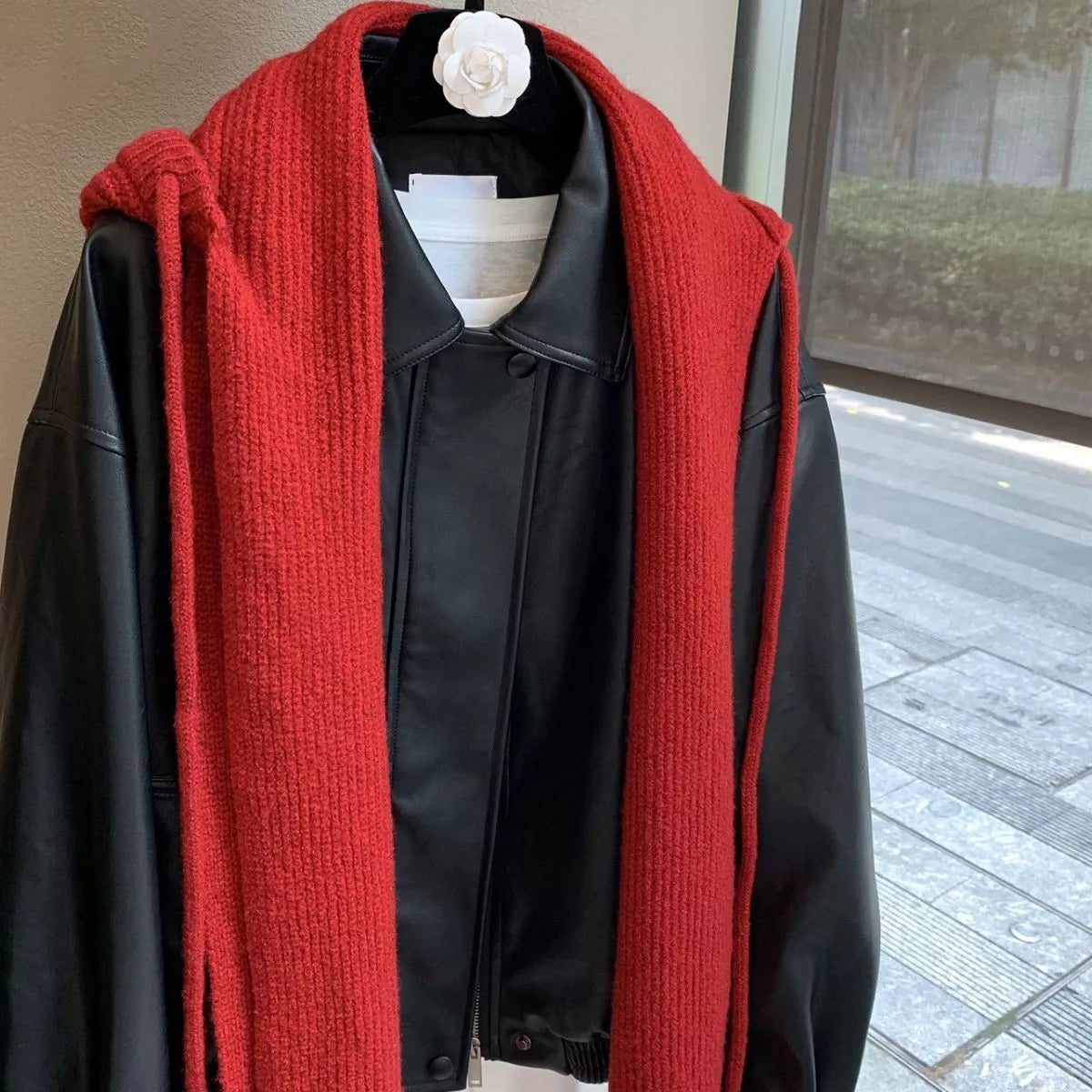 Unisex Hooded Tie Knit Scarf — red hooded scarf loosely knotted on a hanger
