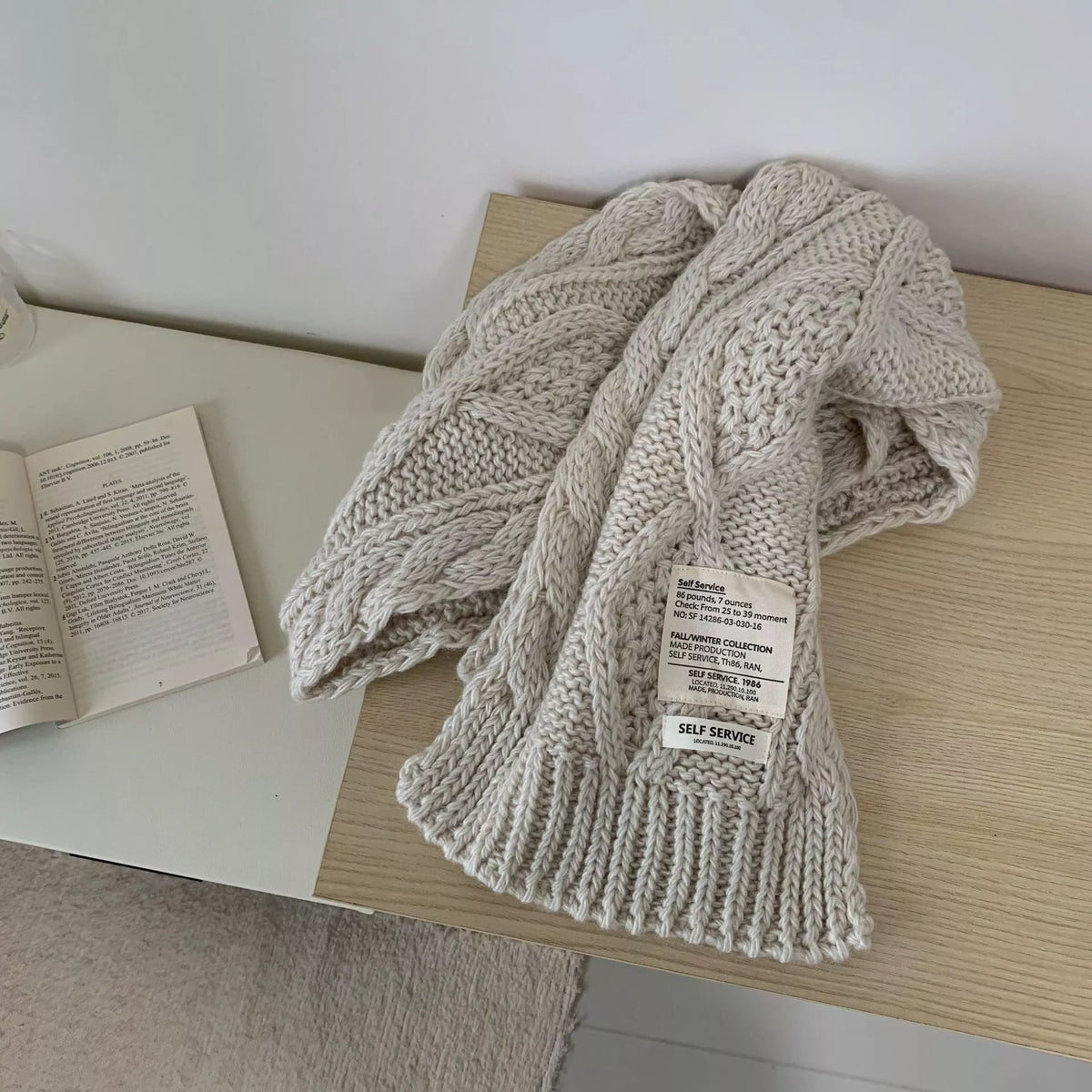 Unisex Chunky Cable Knit Scarf — beige cable scarf tied with a ribbed end panel
