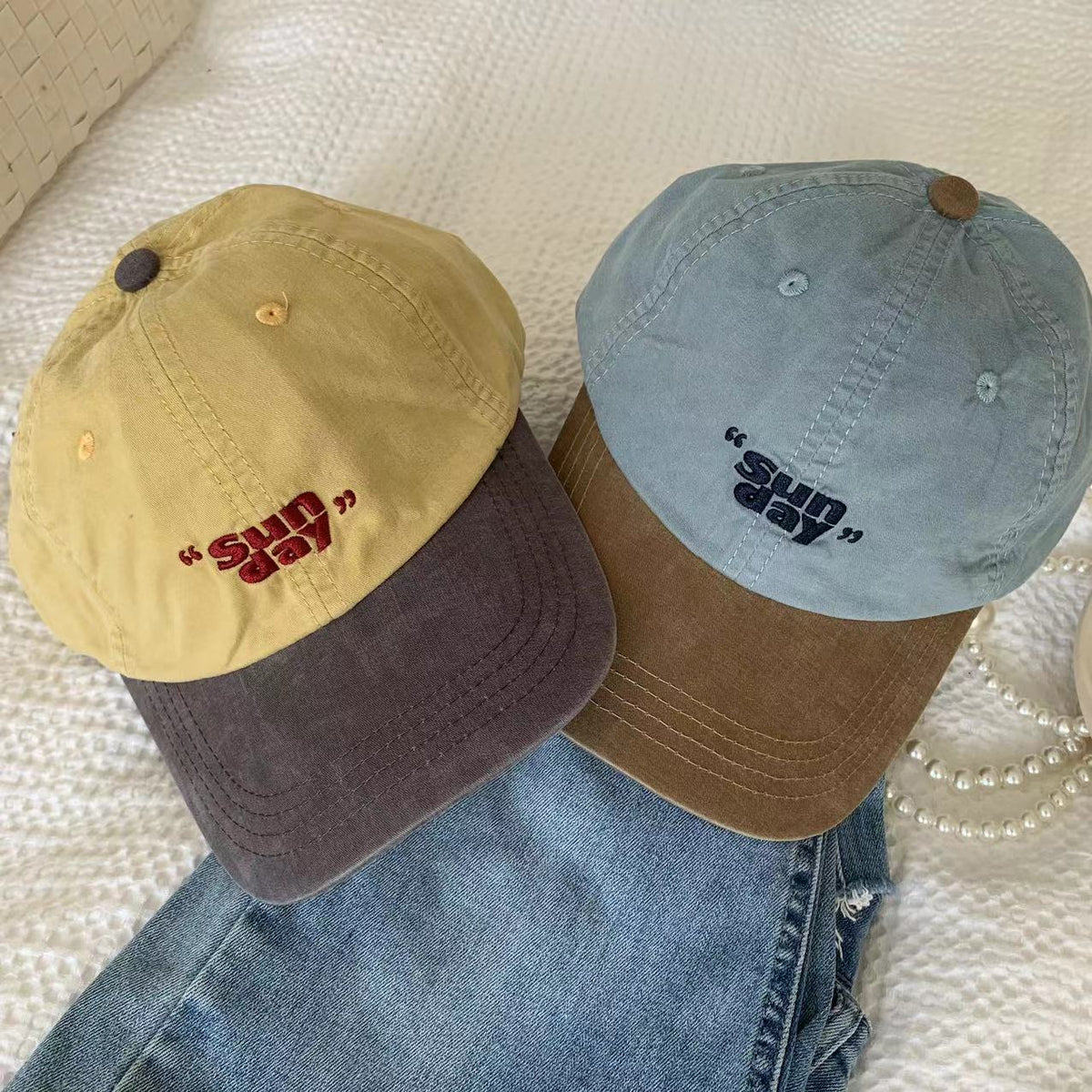 Yellow and blue baseball caps with small front lettering