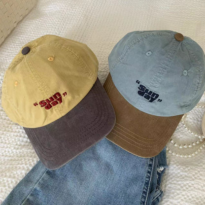 Yellow and blue baseball caps with small front lettering