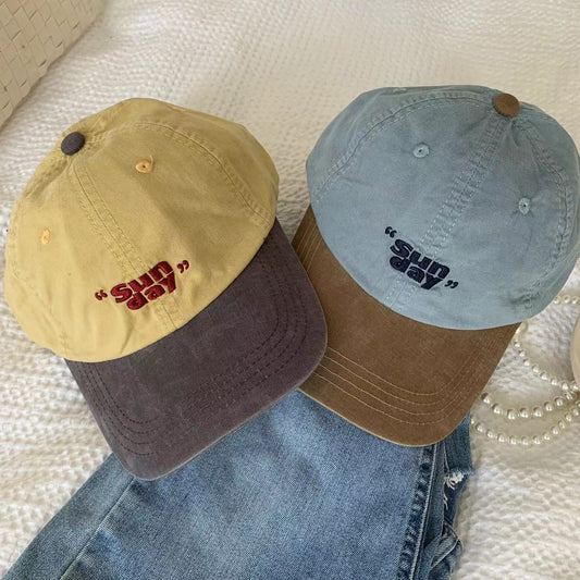Yellow and blue baseball caps with small front lettering