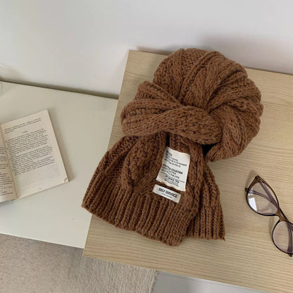 Unisex Chunky Cable Knit Scarf — brown chunky cable scarf tied beside an open book