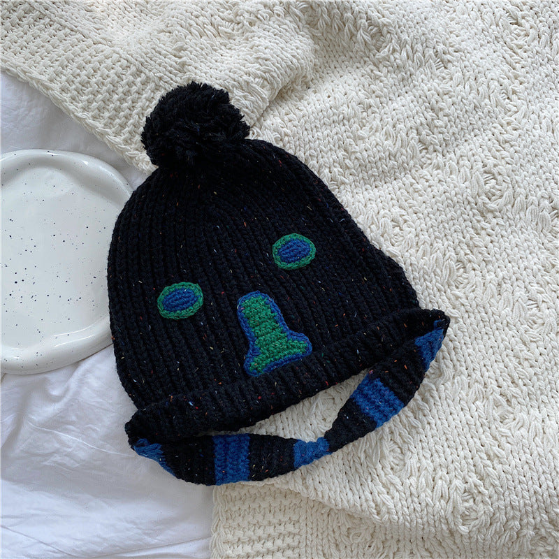 Unisex Cartoon Embroidered Pom Pom Knit Beanie — black knitted beanie with colorful face embroidery