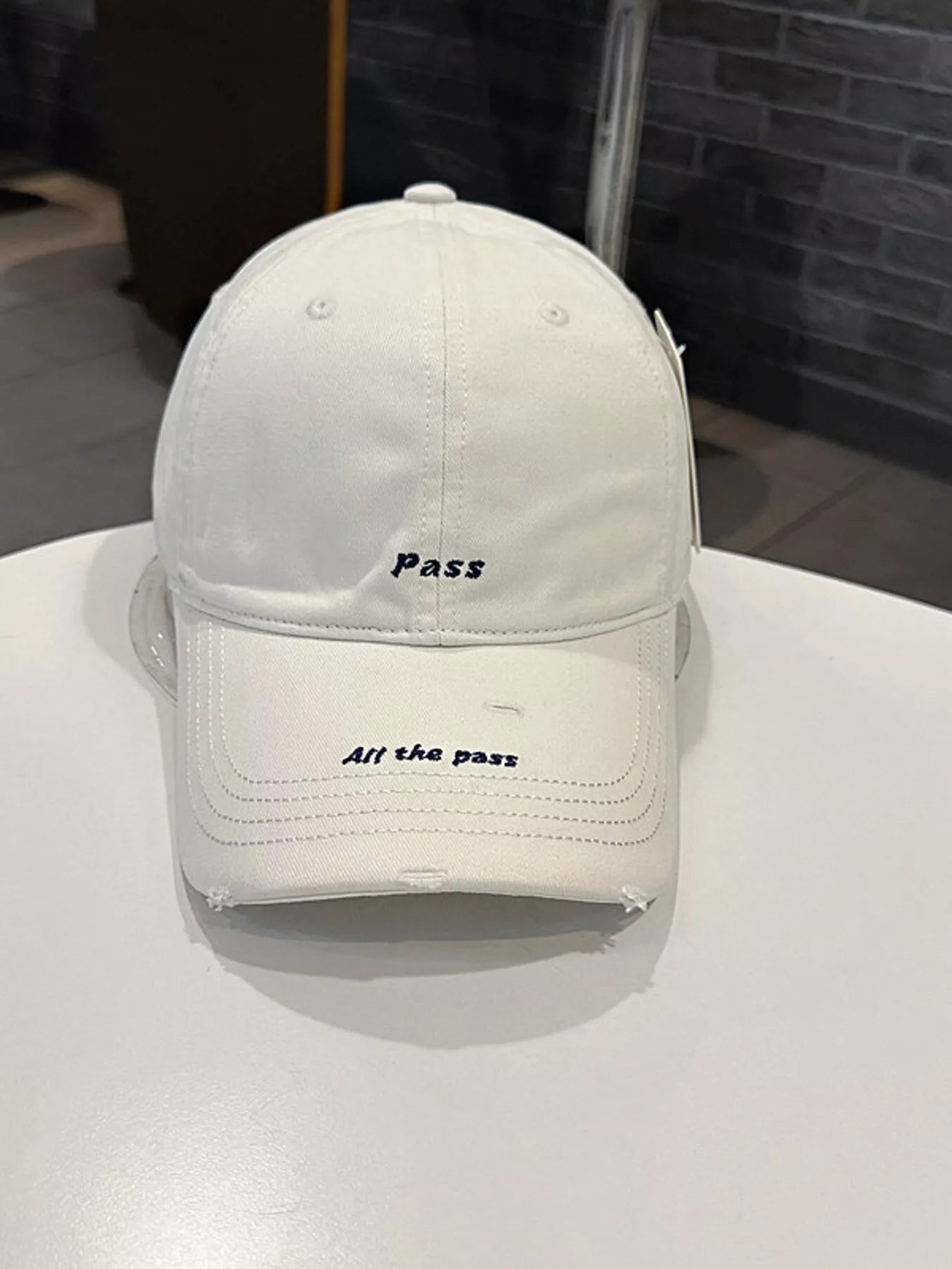 Distressed slogan cap embroidery close-up