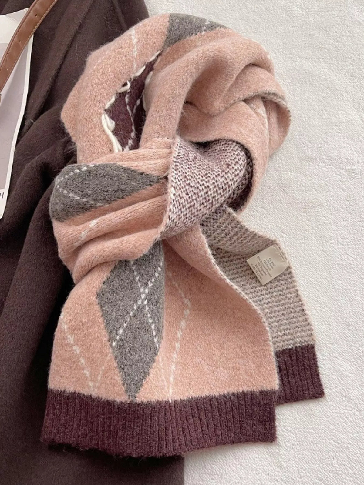 Unisex Classic Argyle Knitted Winter Scarf — pink argyle scarf looped on a flat surface