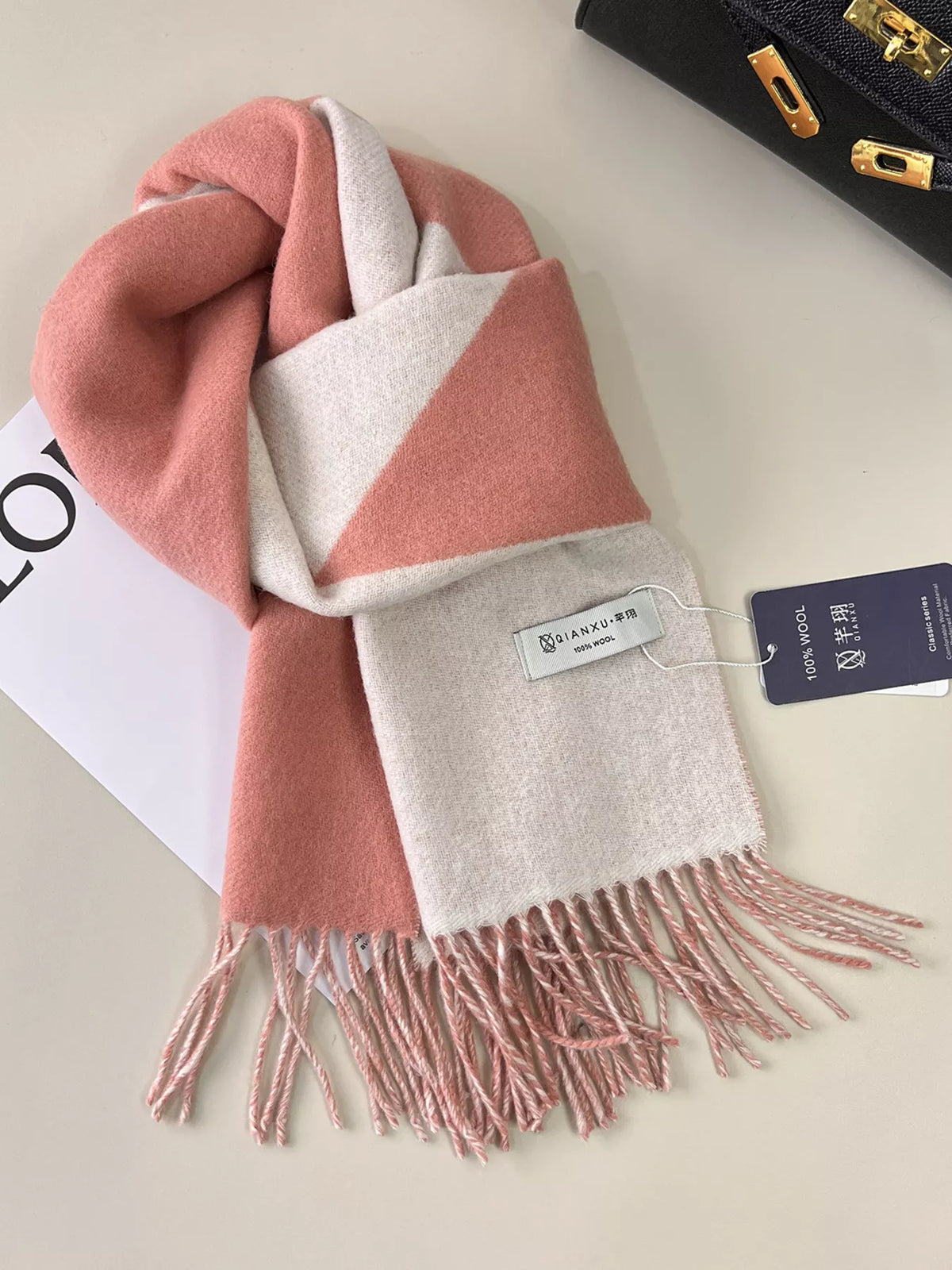 Unisex Fringe Color Block Scarf — pink and beige wool scarf looped on a pale surface