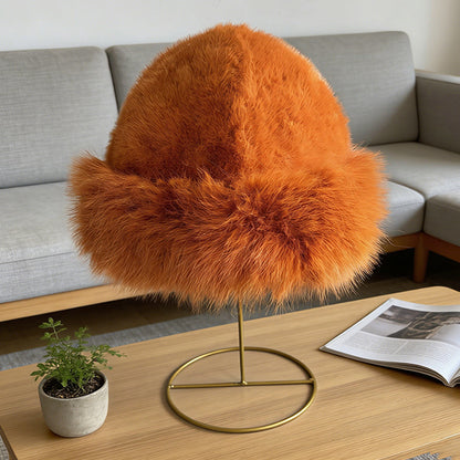 Orange cloche-style faux fur hat on a display stand