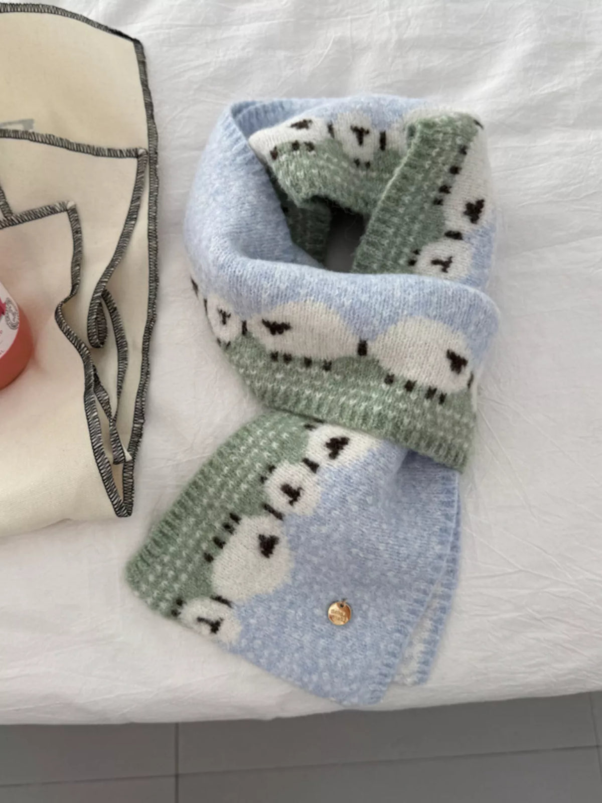 Unisex Sheep Motif Knit Scarf — blue scarf looped with sheep details showing