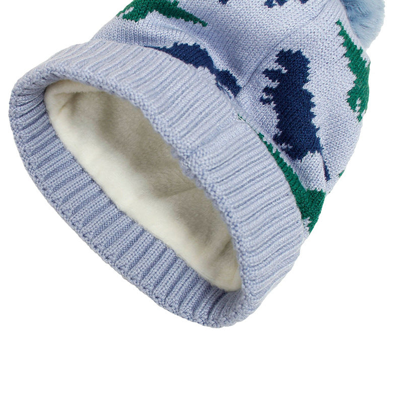 Interior view of a dinosaur beanie showing pale lining and ribbed cuff