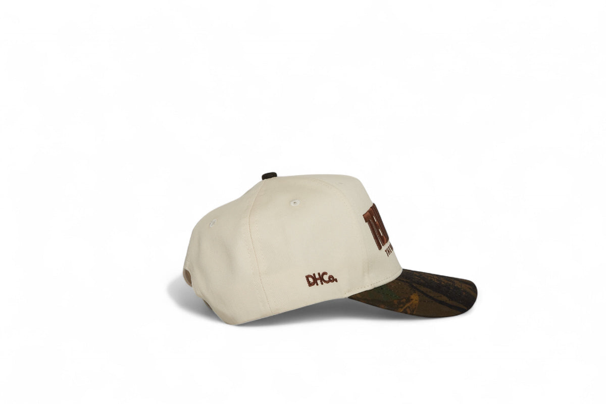 Side profile of the Destination Hat Co. Tennessee camo cap showing the curved bill and side logo