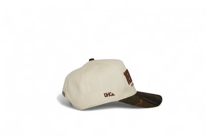 Side profile of the Destination Hat Co. Tennessee camo cap showing the curved bill and side logo