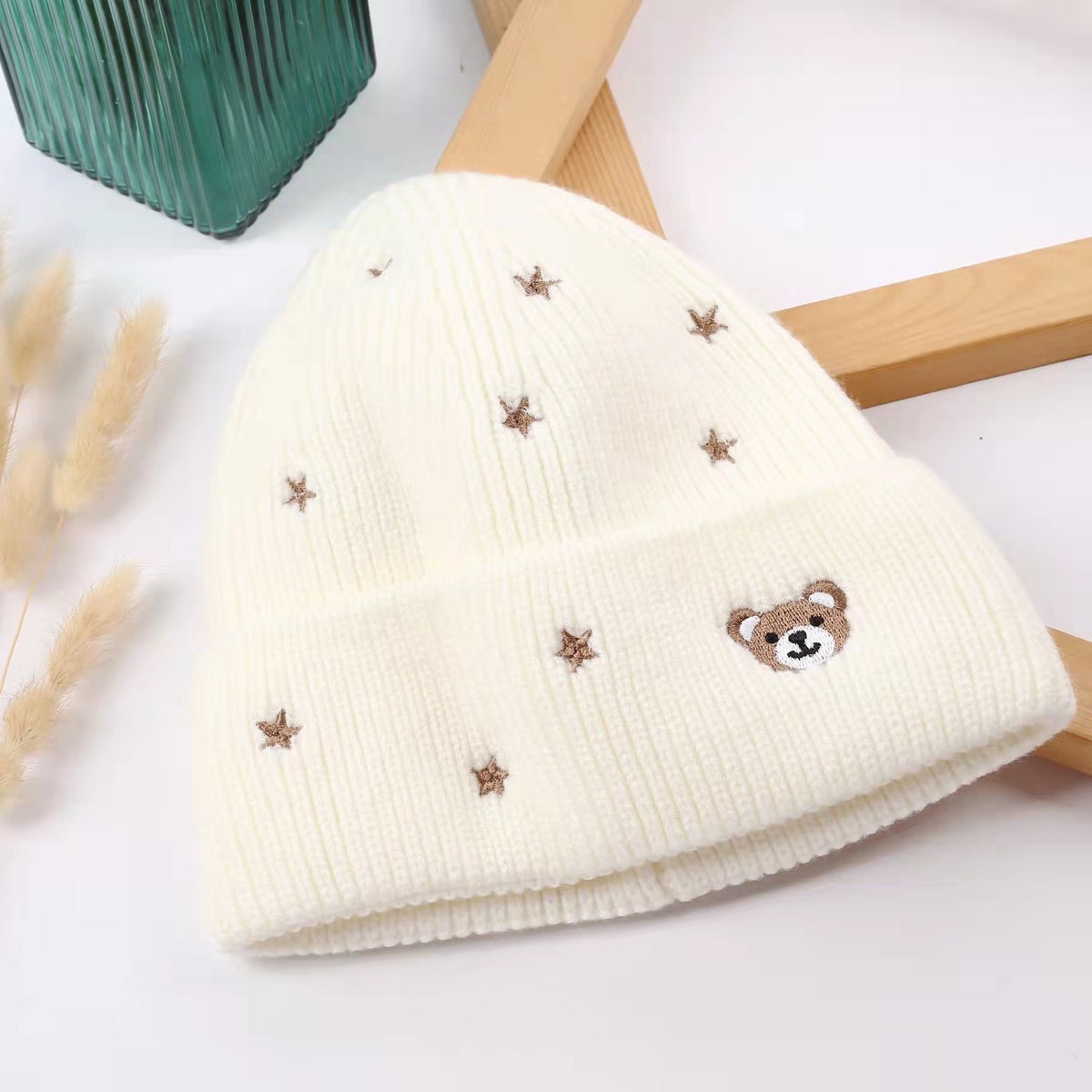 White teddy bear and star winter beanie shown from the front