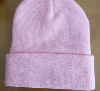 Pink cuffed knit beanie showing its plain rear surface