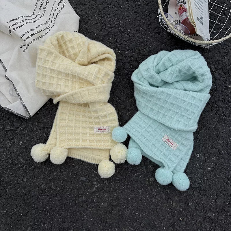Unisex Waffle Knit Pom-Pom Scarf — creamy yellow and mint scarves arranged in loose loops