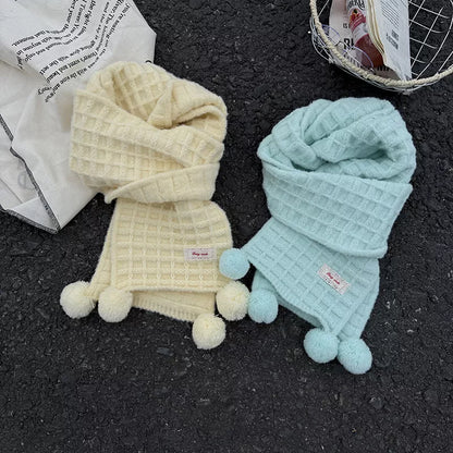 Unisex Waffle Knit Pom-Pom Scarf — creamy yellow and mint scarves arranged in loose loops