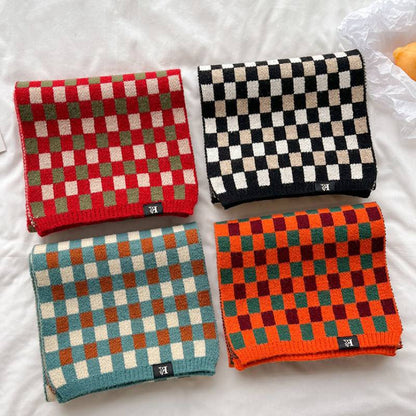 Four checkerboard knit scarves in red black blue and orange colorways
