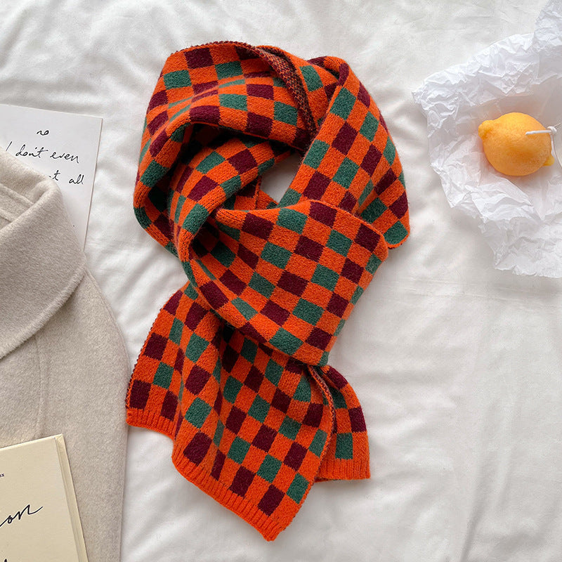 Orange and green checkerboard scarf arranged in a loose knot