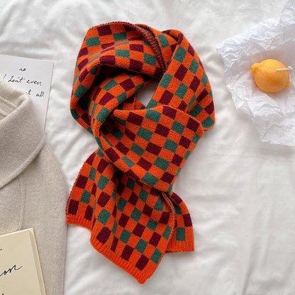 Orange and green checkerboard scarf arranged in a loose knot