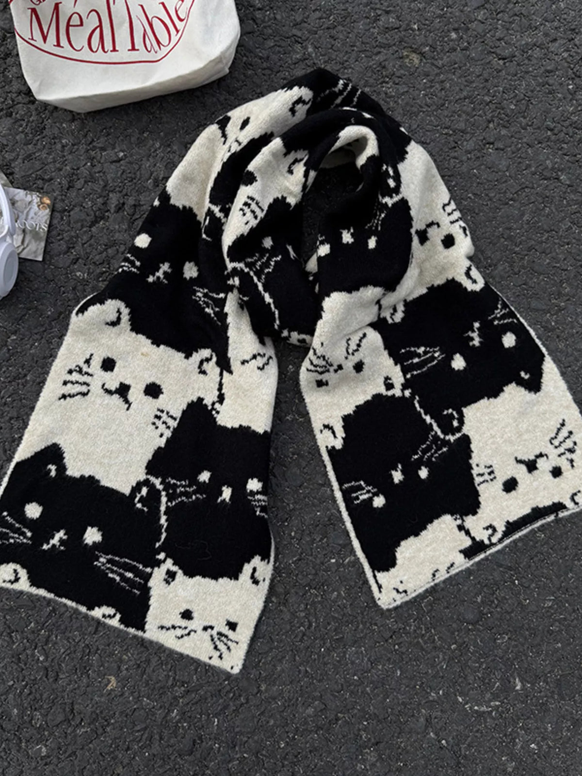 Unisex Allover Cat Knit Scarf — folded black scarf showing contrasting cat faces