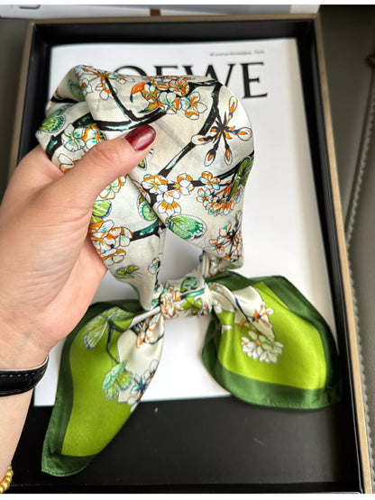 Unisex Floral Print Silk Scarf — green bordered scarf gathered loosely in one hand