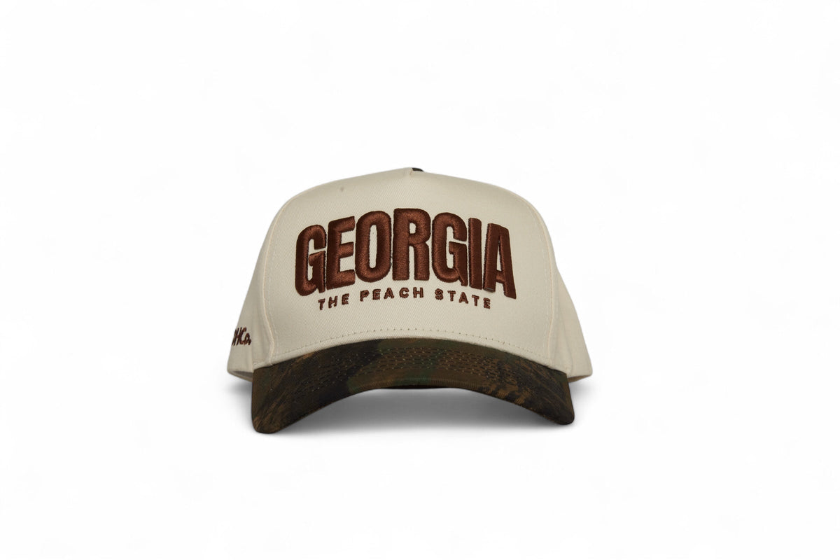 Front view of the Destination Hat Co. Georgia camo cap with brown embroidery