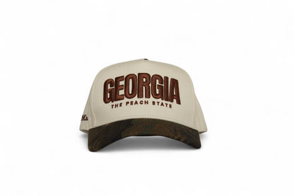 Front view of the Destination Hat Co. Georgia camo cap with brown embroidery