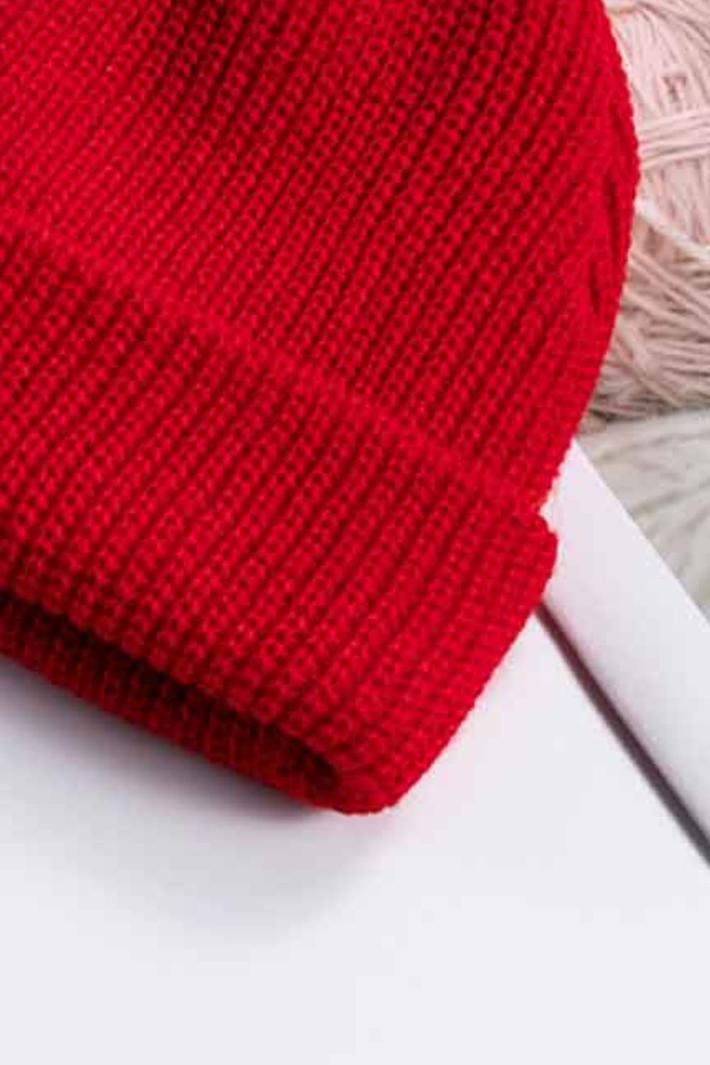 White rib-knit cuff beanie clean studio view