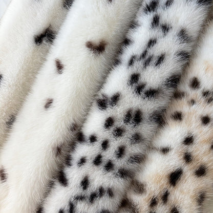 Detailed view of white spotted and leopard faux fur scarf fabrics