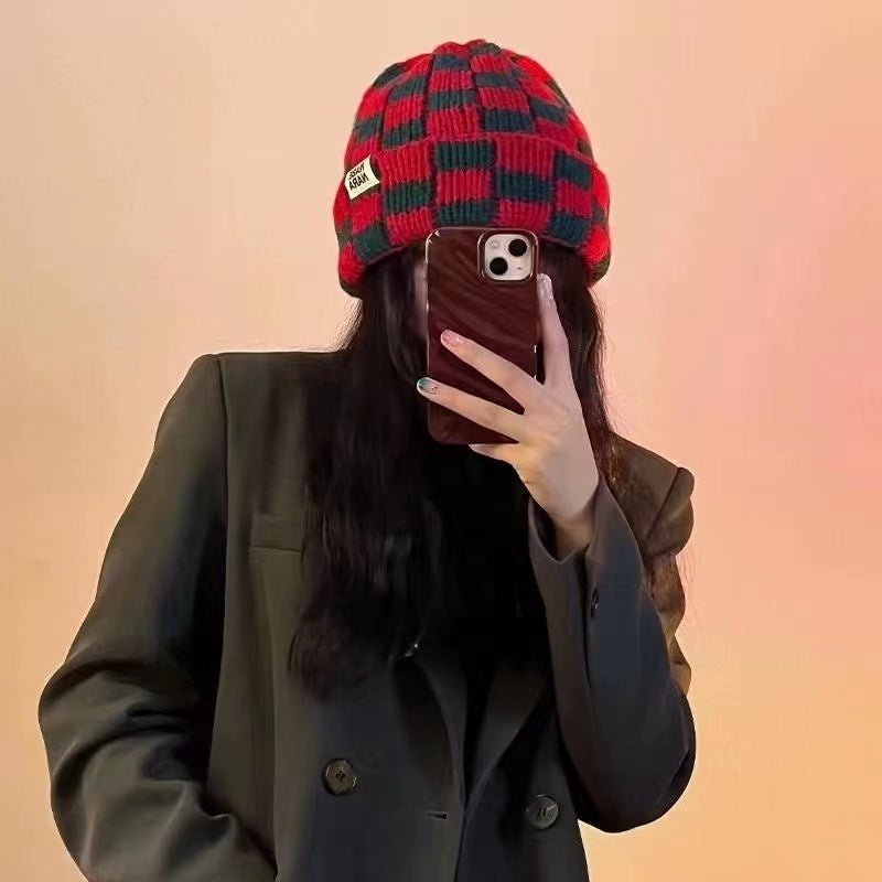 Red and dark green checkerboard beanie worn with a dark jacket