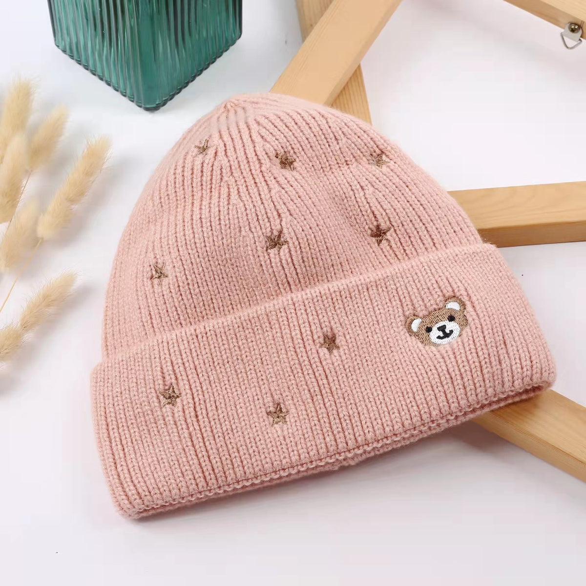 Pink cuffed beanie with teddy bear and star details