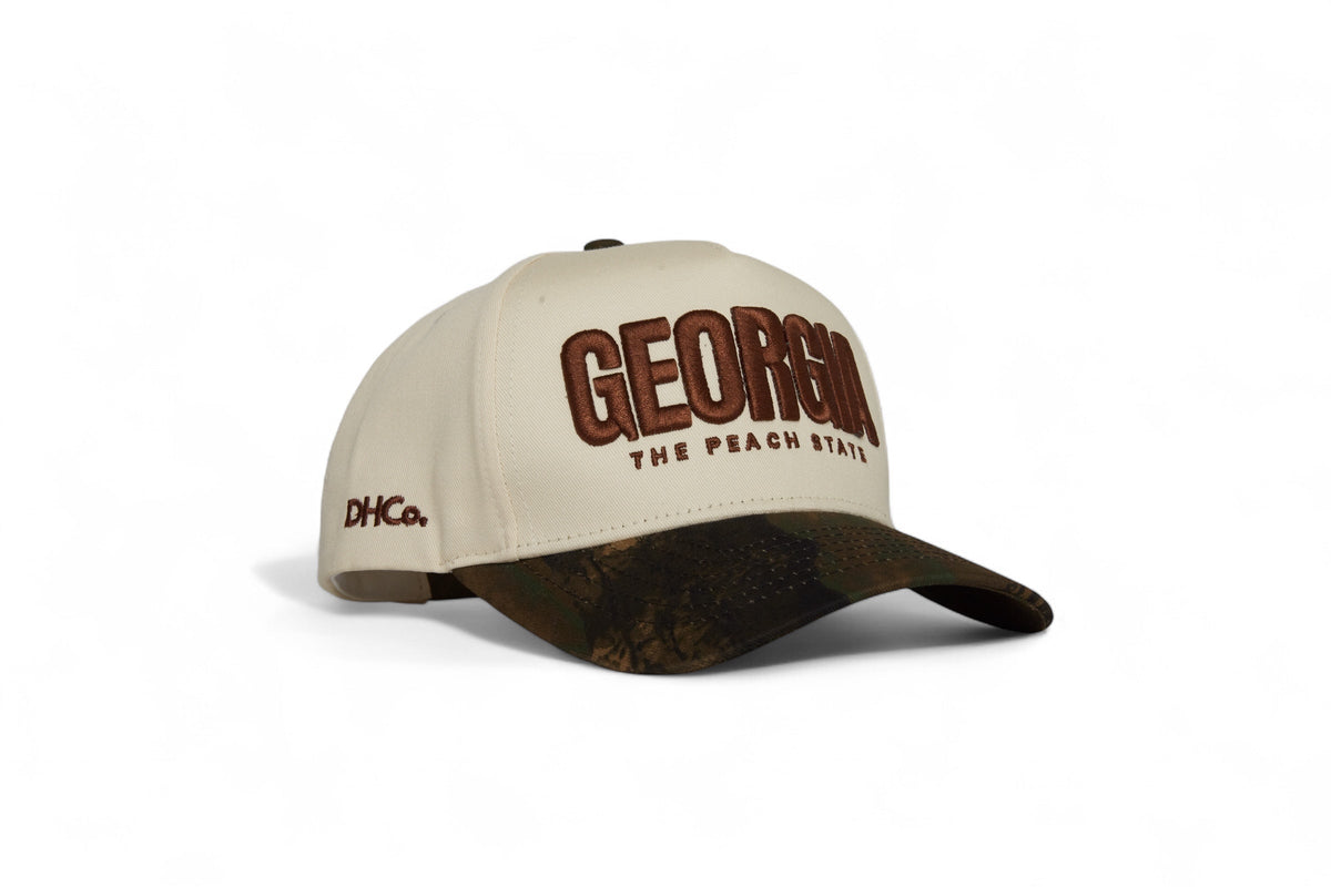 Destination Hat Co. Georgia camo cap with beige crown and camouflage bill, angled view