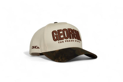 Destination Hat Co. Georgia camo cap with beige crown and camouflage bill, angled view