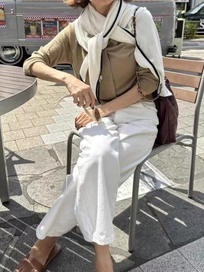 Unisex 100% Wool Contrast Trim Scarf — pale pointed scarf styled over a taupe sweater outdoors