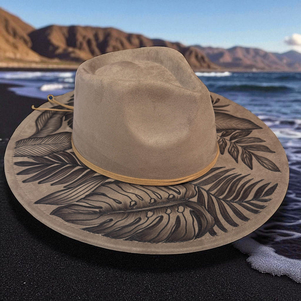 Light taupe High Definition fedora showing leafy pyrography across its wide brim