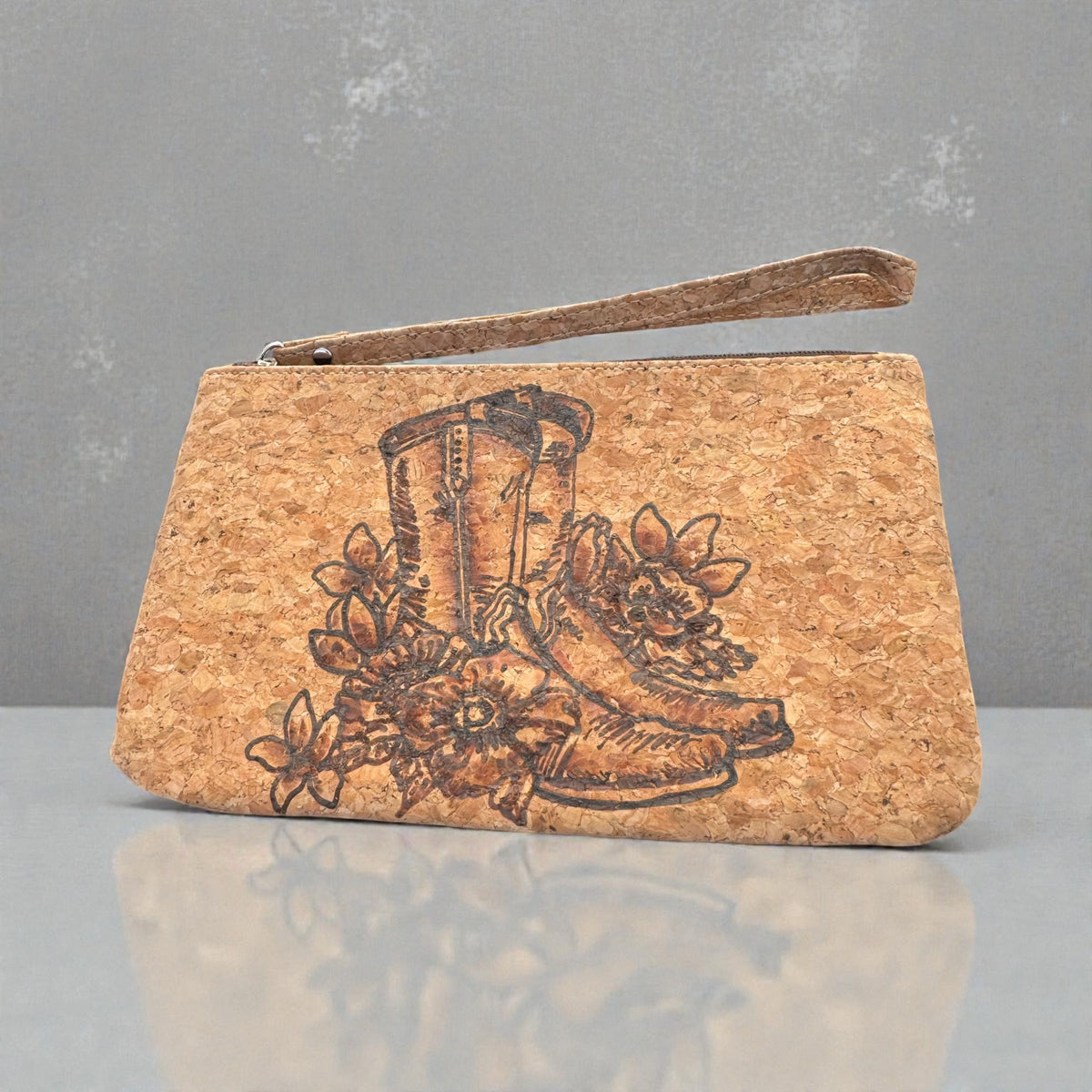 Piper Boots & Blooms cork wristlet with burned cowboy boot and flowers, zipper and wrist strap visible