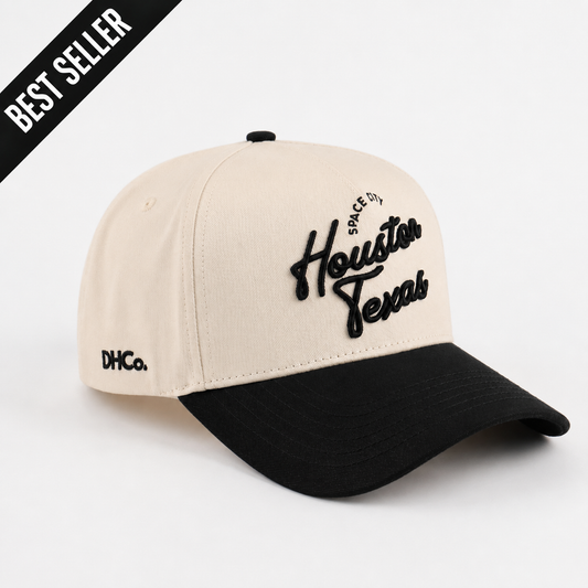 Destination Hat Co. Houston script cap with beige crown and black bill, angled view