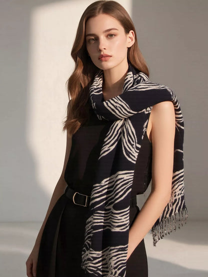 Unisex Geometric Patterned Fringe Scarf — black and pale patterned scarf draped at the neck