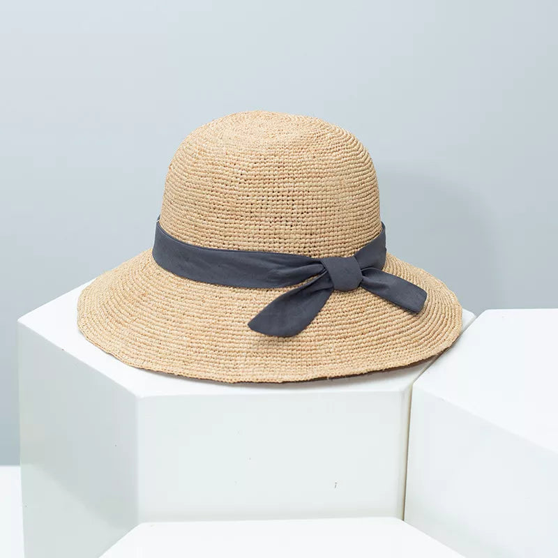 Resort style straw ribbon sun hat studio angle