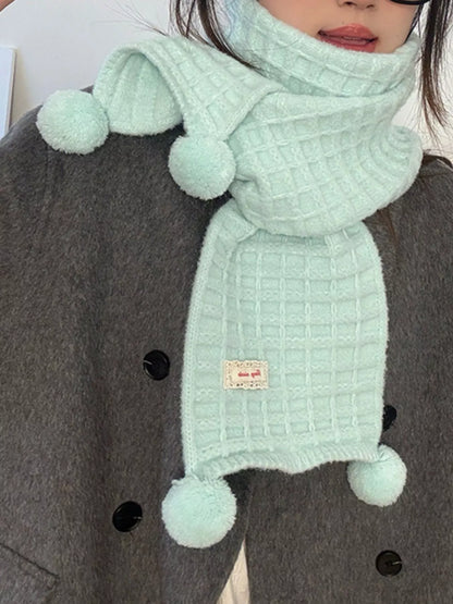 Unisex Pastel Waffle Knit Scarf — closer view of a mint waffle scarf tied over a coat