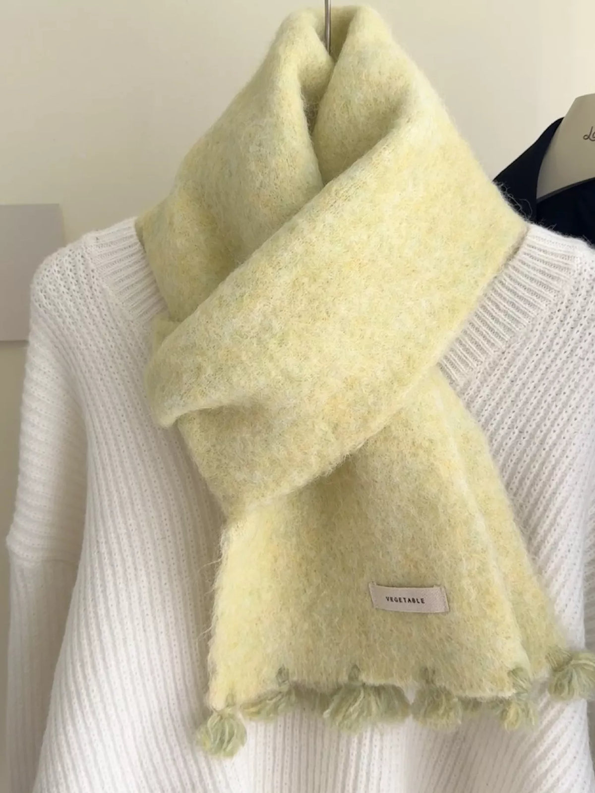 Unisex Tassel Knitted Scarf — close view of a pale yellow wool scarf at the neckline
